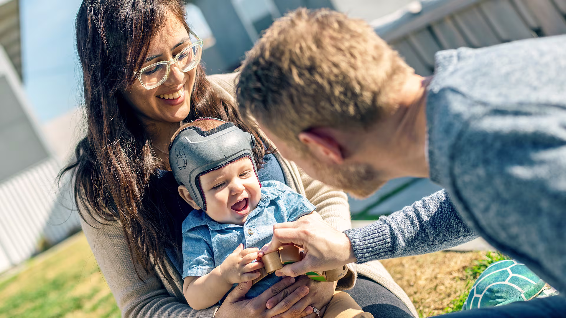 Parents playing with their baby wearing an Ottobock MyCRO Band 