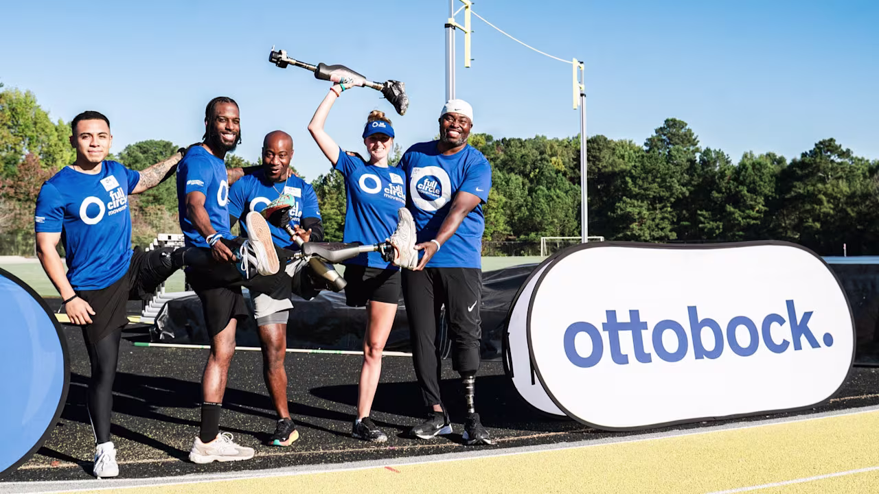 A group of Full Circle Movement by Ottobock attendees posing with their leg prostheses