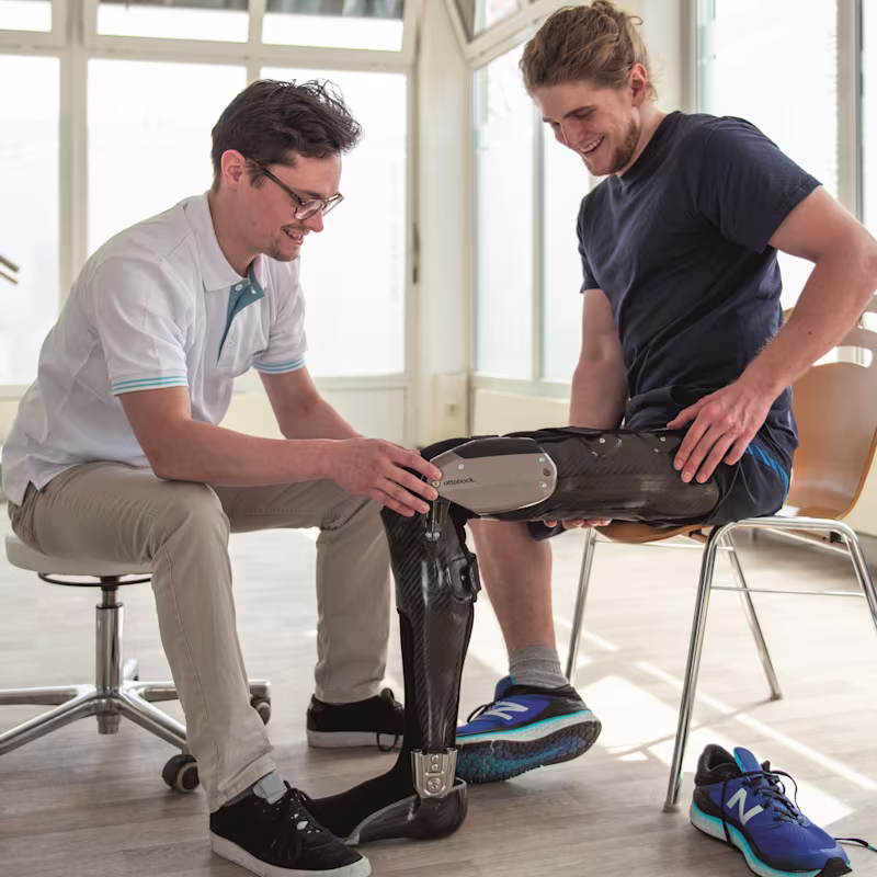 A clinician helps a client during a fitting for the Ottobock C-Brace