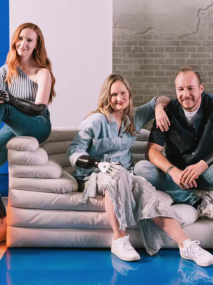 Three people with limb loss or limb difference using prosthetic arms and hands.