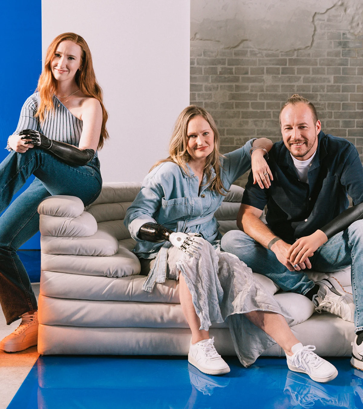 Three people with limb loss or limb difference using prosthetic arms and hands. 