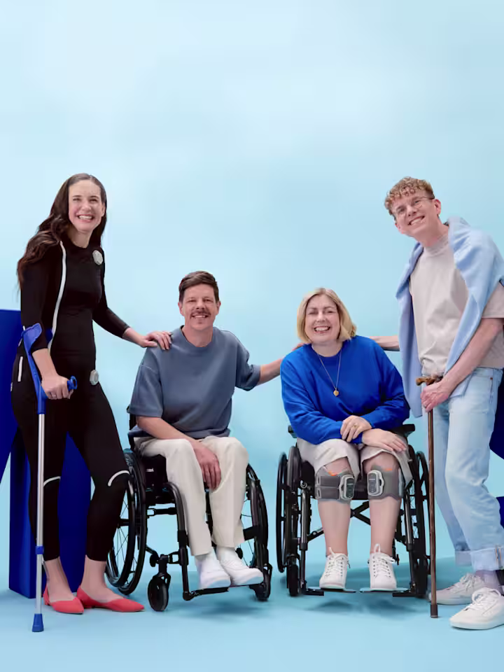Ottobock product users standing smilingly in front of big blue MS letters