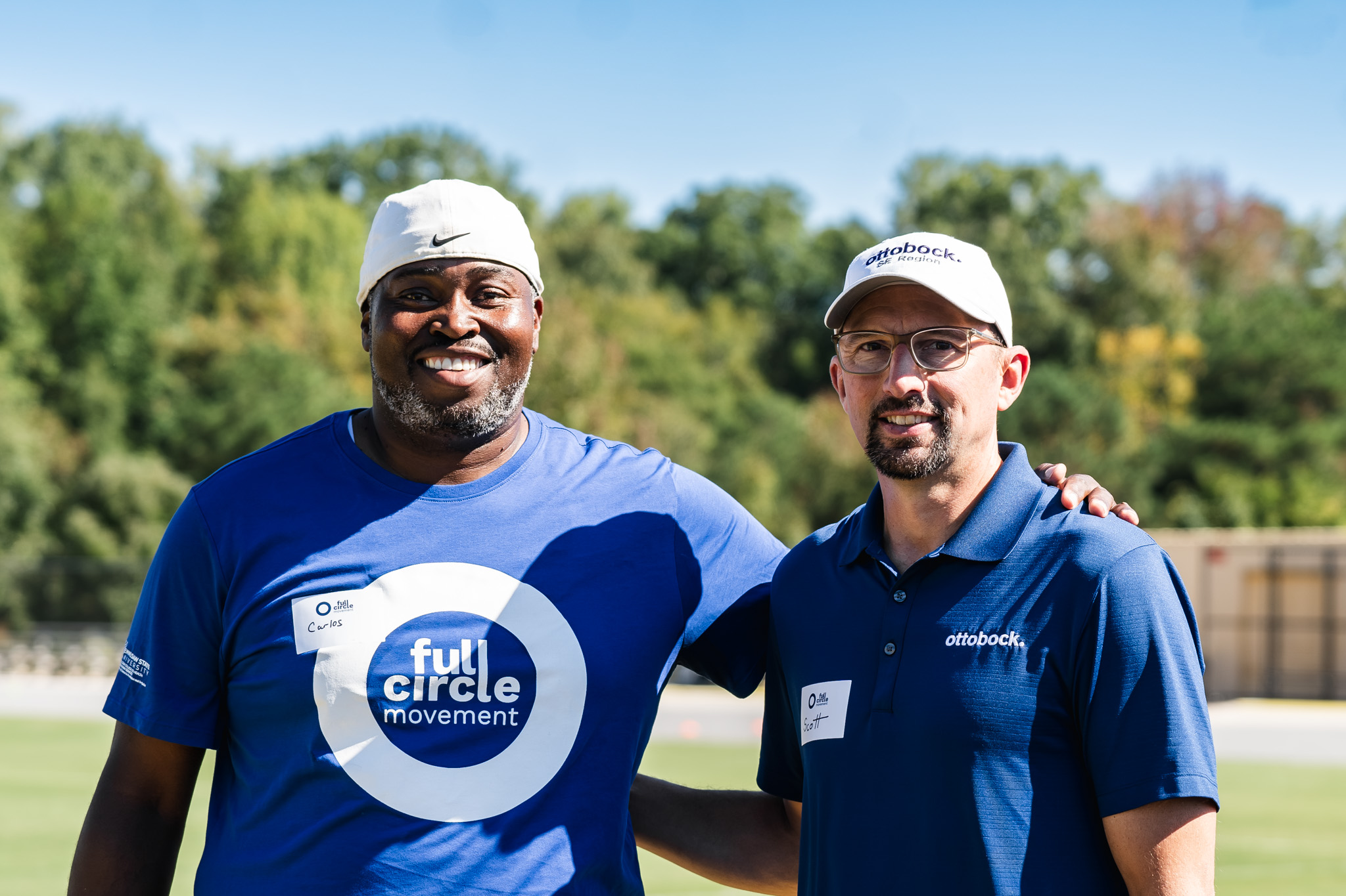 A volunteer and event attendee in a friendly hug at the Ottobock Full Circle Movement event