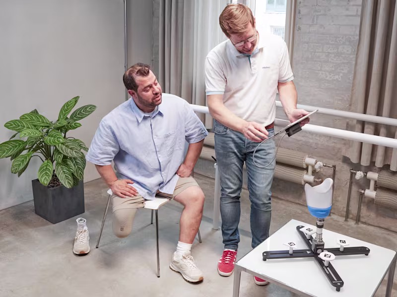 Ottobock technician and prosthetic leg user in a clinical setting scanning a test socket using Transfer Scan Solution.
