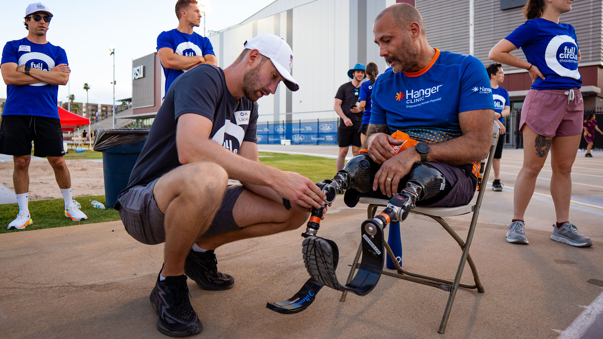 Ottobock Clinical Specialist, Lucas Crisanti, adjusting a prosthetic device on an amputee at Full Circle Movement Desert Challenge Games