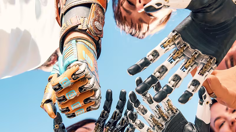A group of smiling people standing in a circle, reaching their prosthetic hands toward the center against a bright blue sky, symbolizing community, technology, and empowerment.