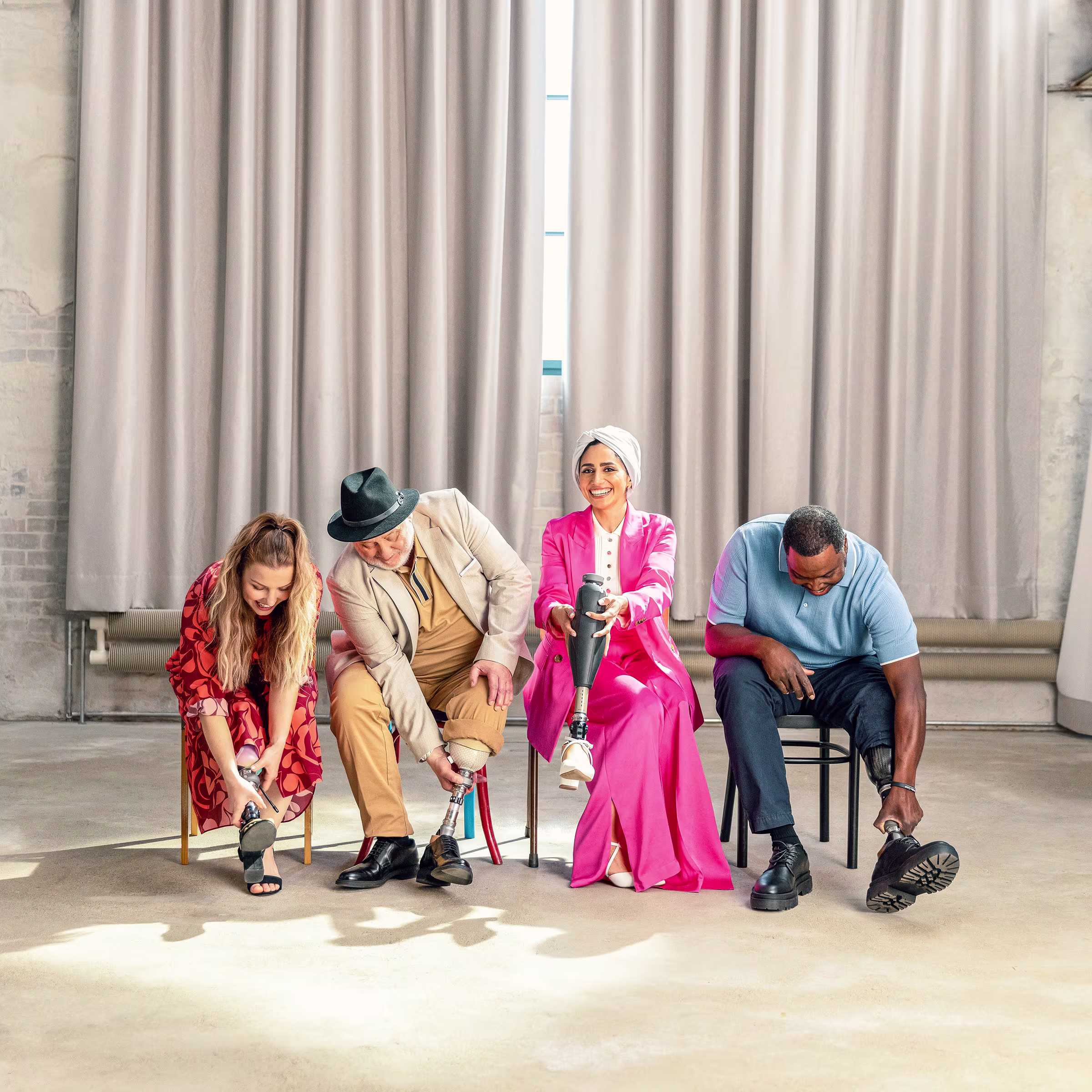 A group of prosthetic foot users sitting in a row while they adjust their devices