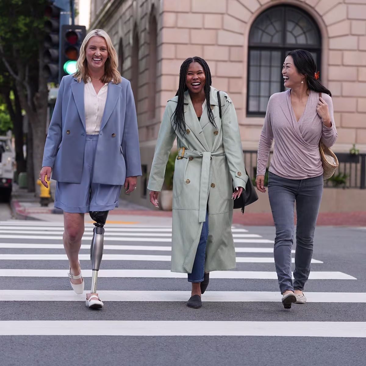 A group of women crossing the street, one wearing a C-Leg by Ottobock