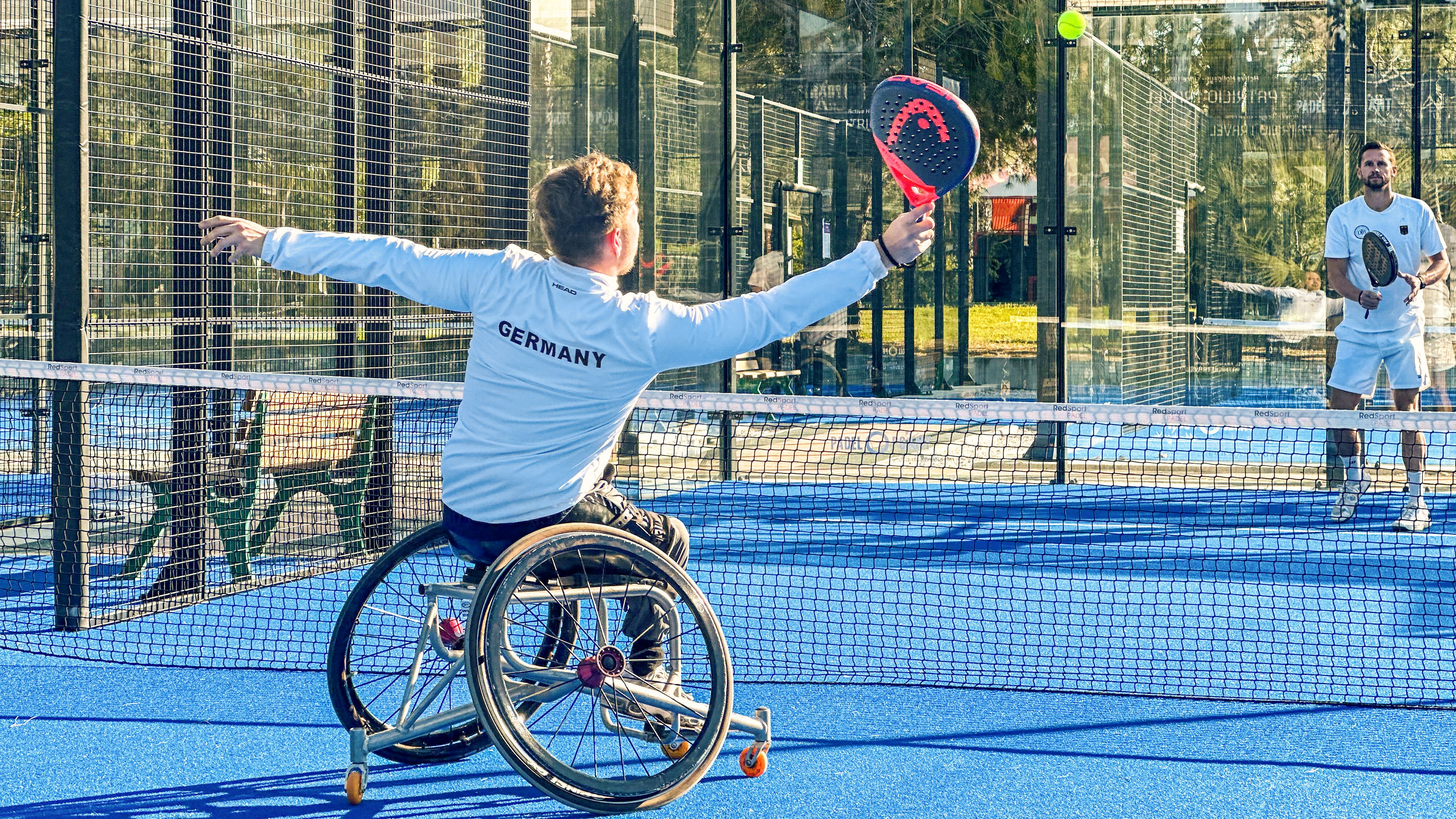 Athlete from Germany playing padel with coach on court.