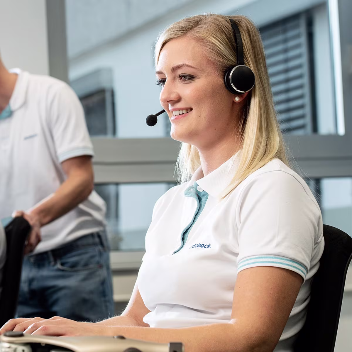 An Ottobock Professional on the phone with a customer to provide product support