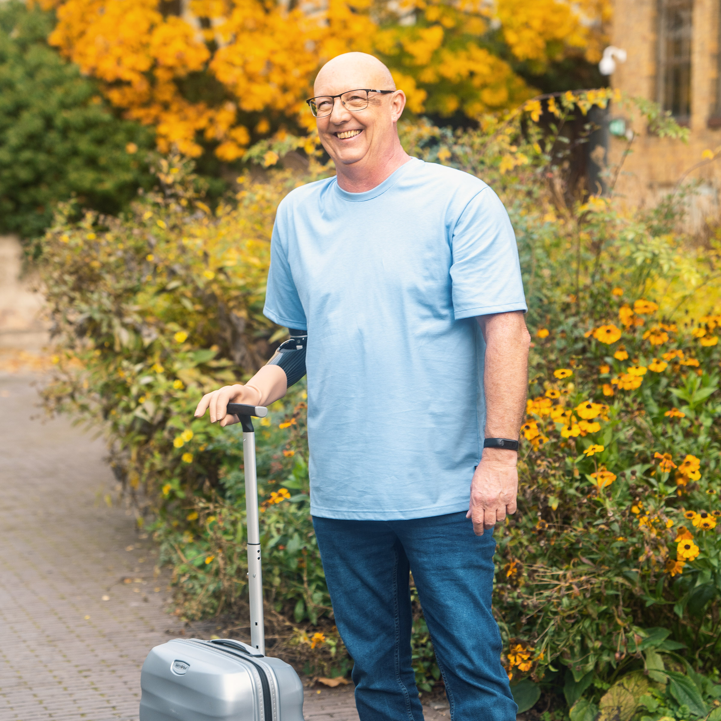 Ottobock user Ralf carrying his trolley luggage.