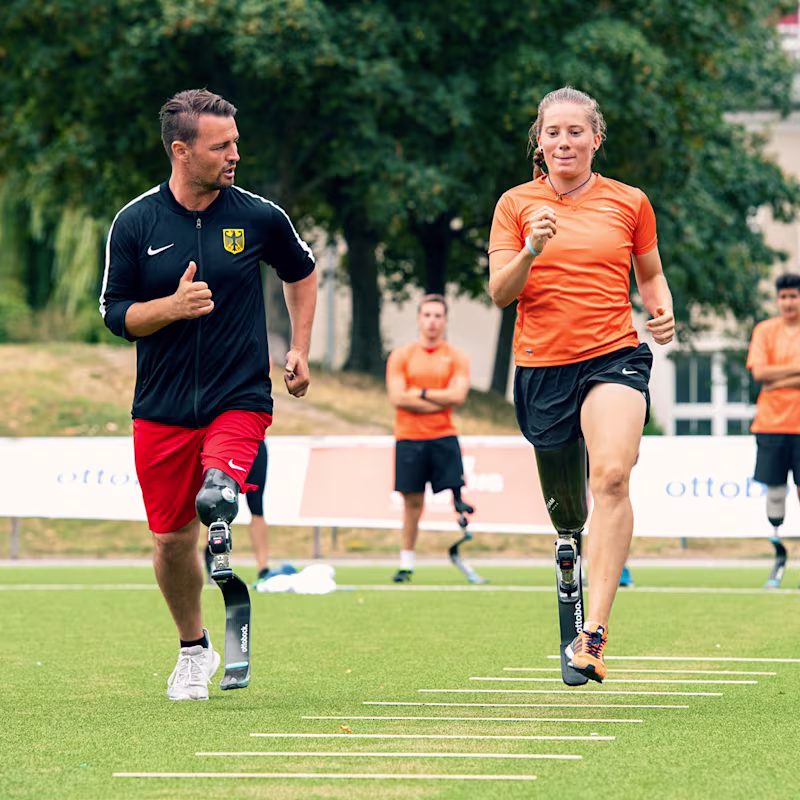 Athletes running beside each other outside