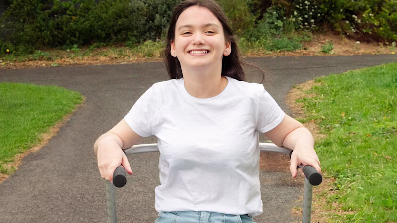 Cerebral Palsy patient walks with her walker