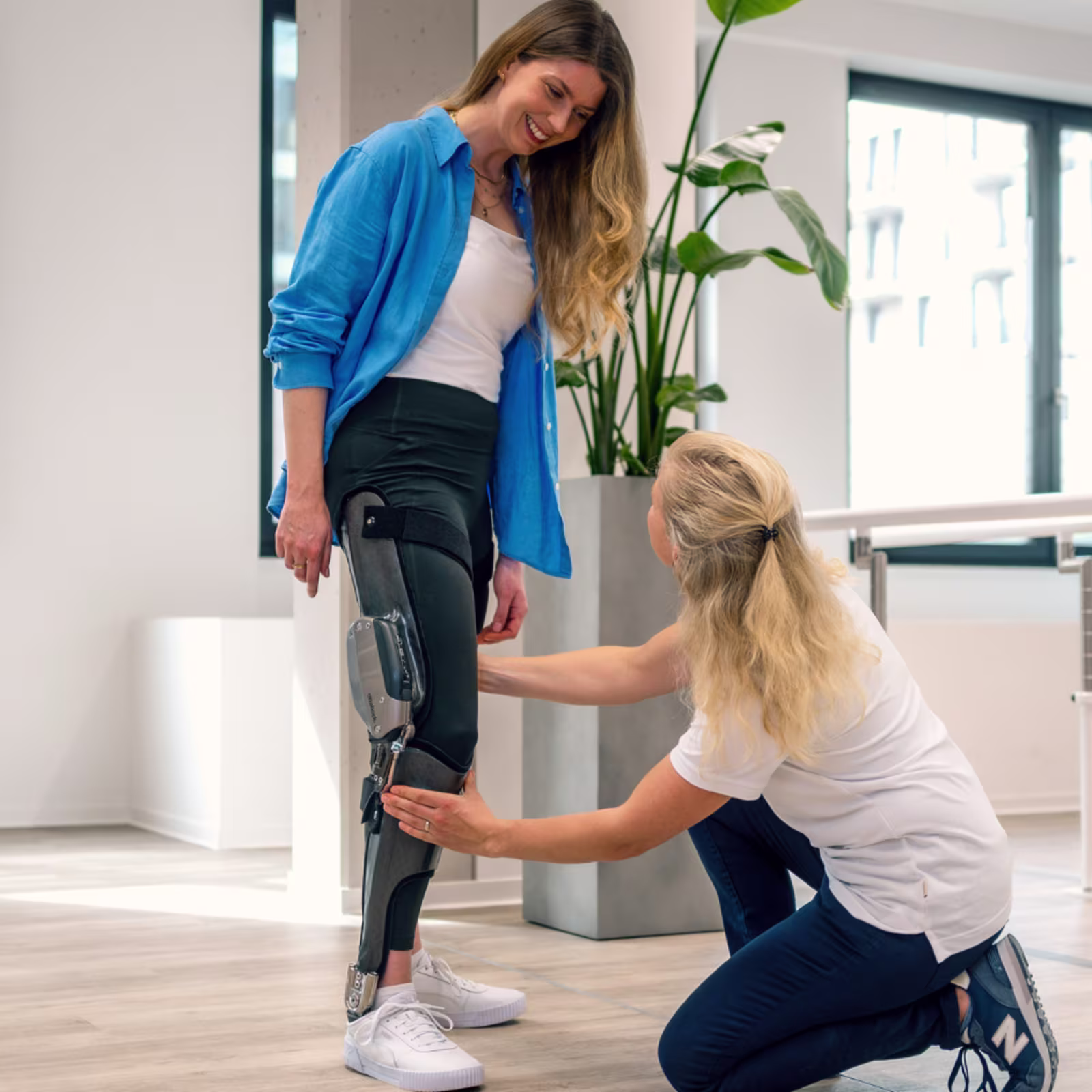 A woman is being fitted with the Ottobock C-Brace knee ankle foot orthosis (KAFO) in a clinic