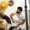 A bilateral amputee getting fitted for prosthetic legs by a CPO
