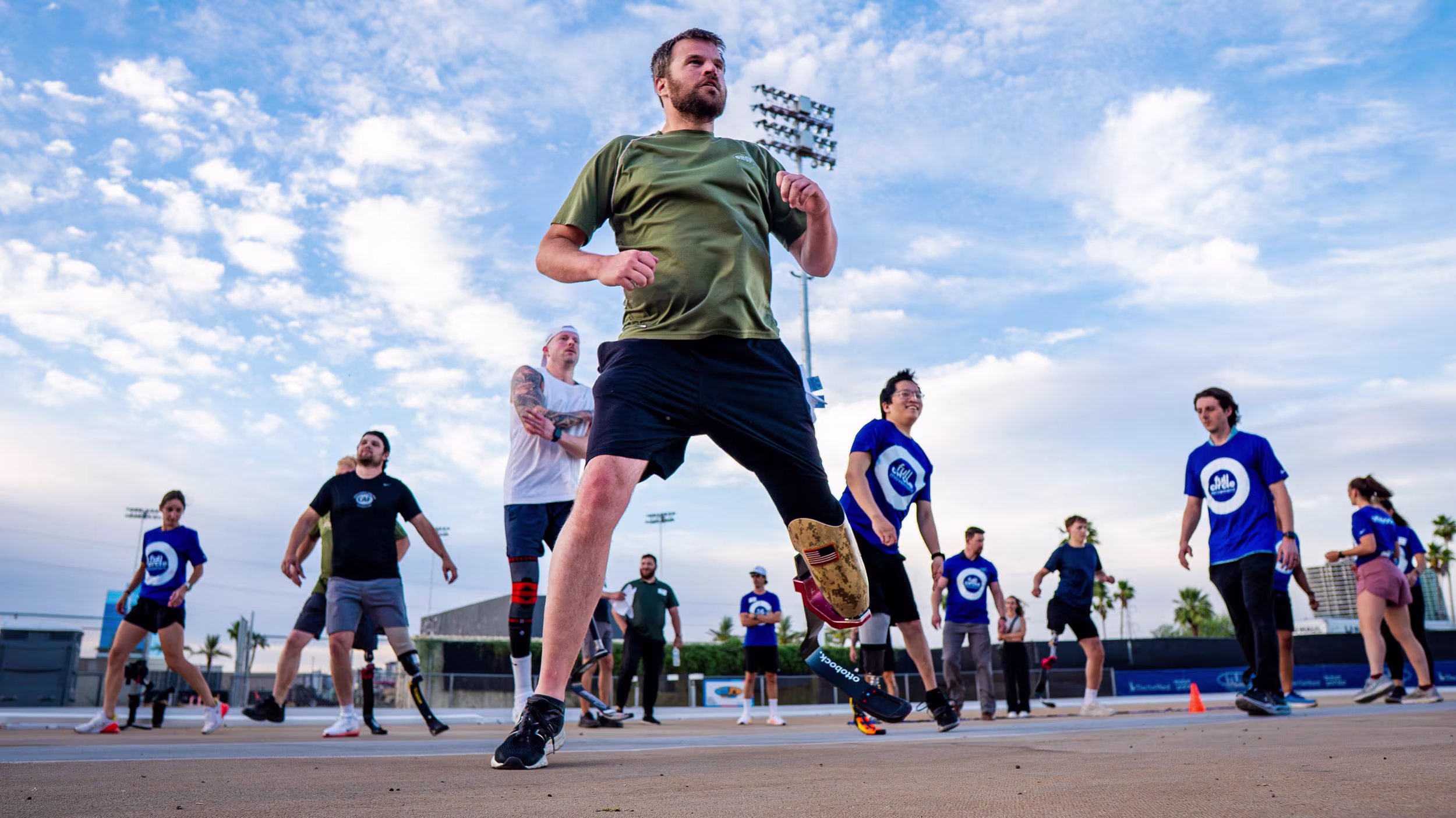 An below-knee amputee wearing an Ottobock prosthetic running blade doing warm ups before the Full Circle Movement event in Ypsilanti, MI