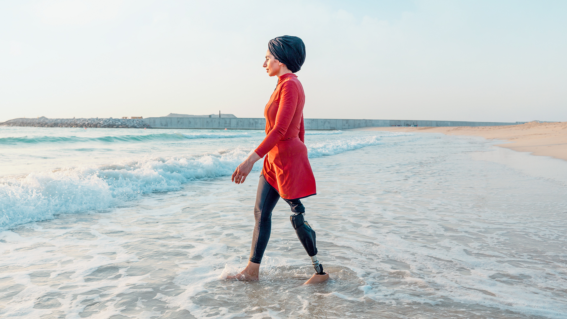 A male surfer riding the waves while wearing his Ottobock Genium X4. 