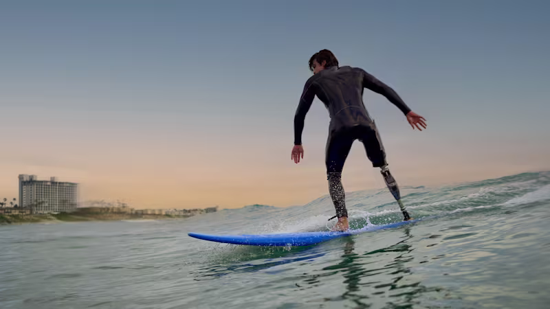 A male surfer riding the waves while wearing his Ottobock Genium X4.