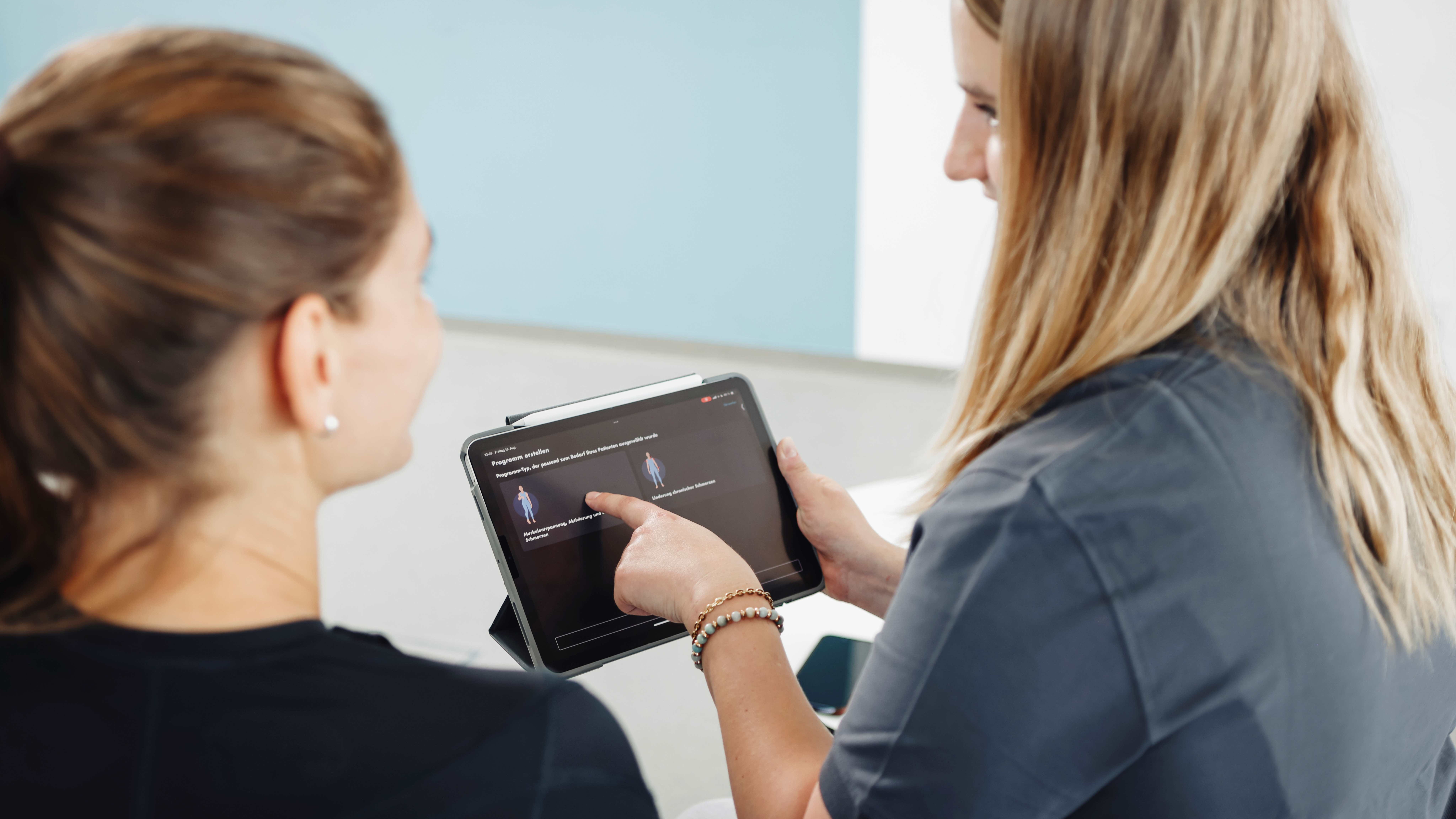 Healthcare professional explains the set-up in the exopulse suit app.