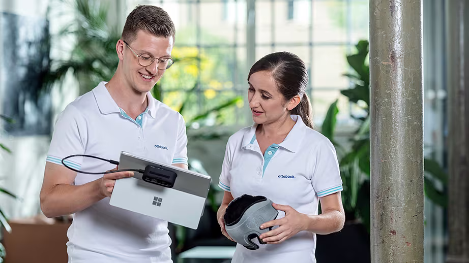 Two plagiocephaly experts looking at tablet one holding a Ottobock MyCRO Band