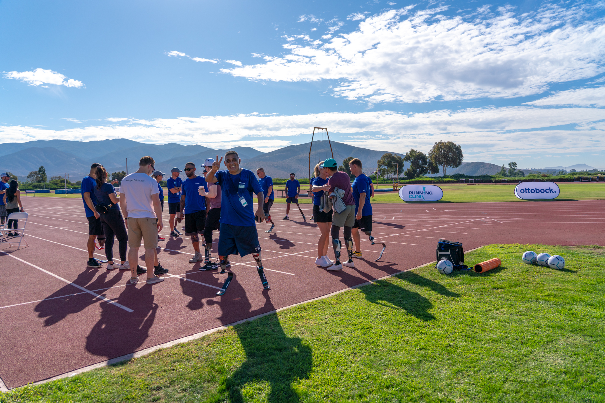 An amputee posing for the camera on an outdoor running track