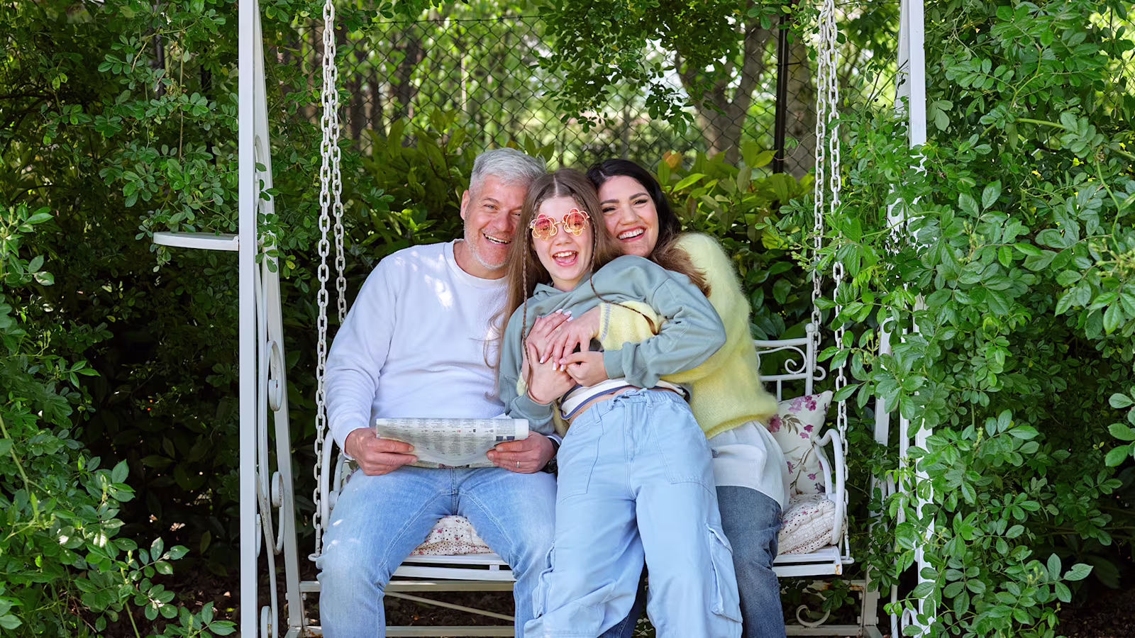 Ottobock Exopulse Mollii Suit user Elisa with family on garden swing
