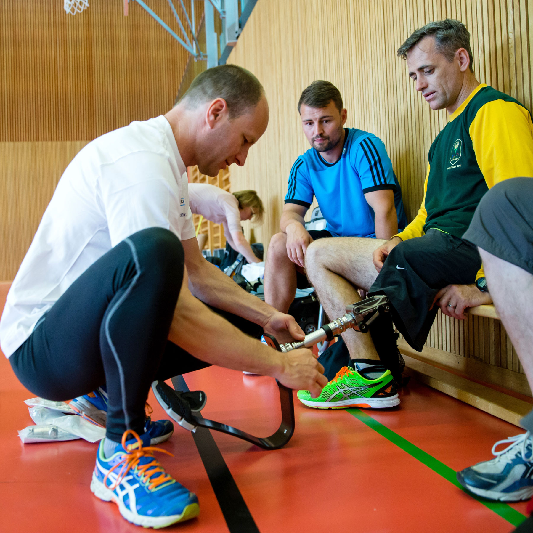 A Certified Prosthetist Orthotist configuring a running blade on an adaptive athlete