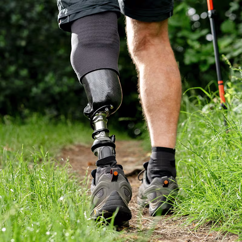 A Taleo Harmony prosthetic foot user walking on an outdoor hiking trail