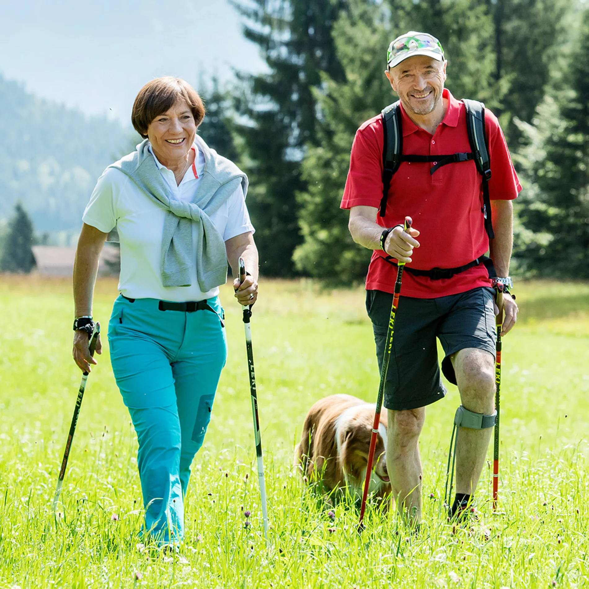Elderly couple walking with their dog through a field while sporting the Ottobock Agilium Freestep