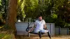A male bilateral amputee sits on a swing and shows off his two Genium microprocessor knees, a pair of advanced prostheses for veterans.