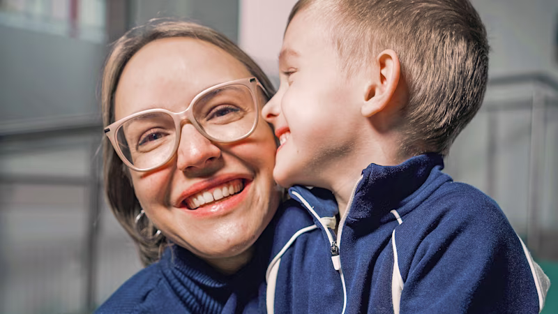 Cerebral palsy patient kissing his mother
