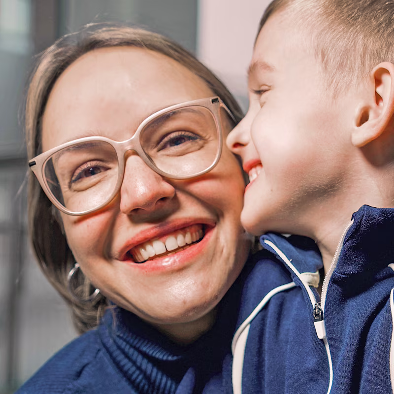 Cerebral palsy patient kissing his mother