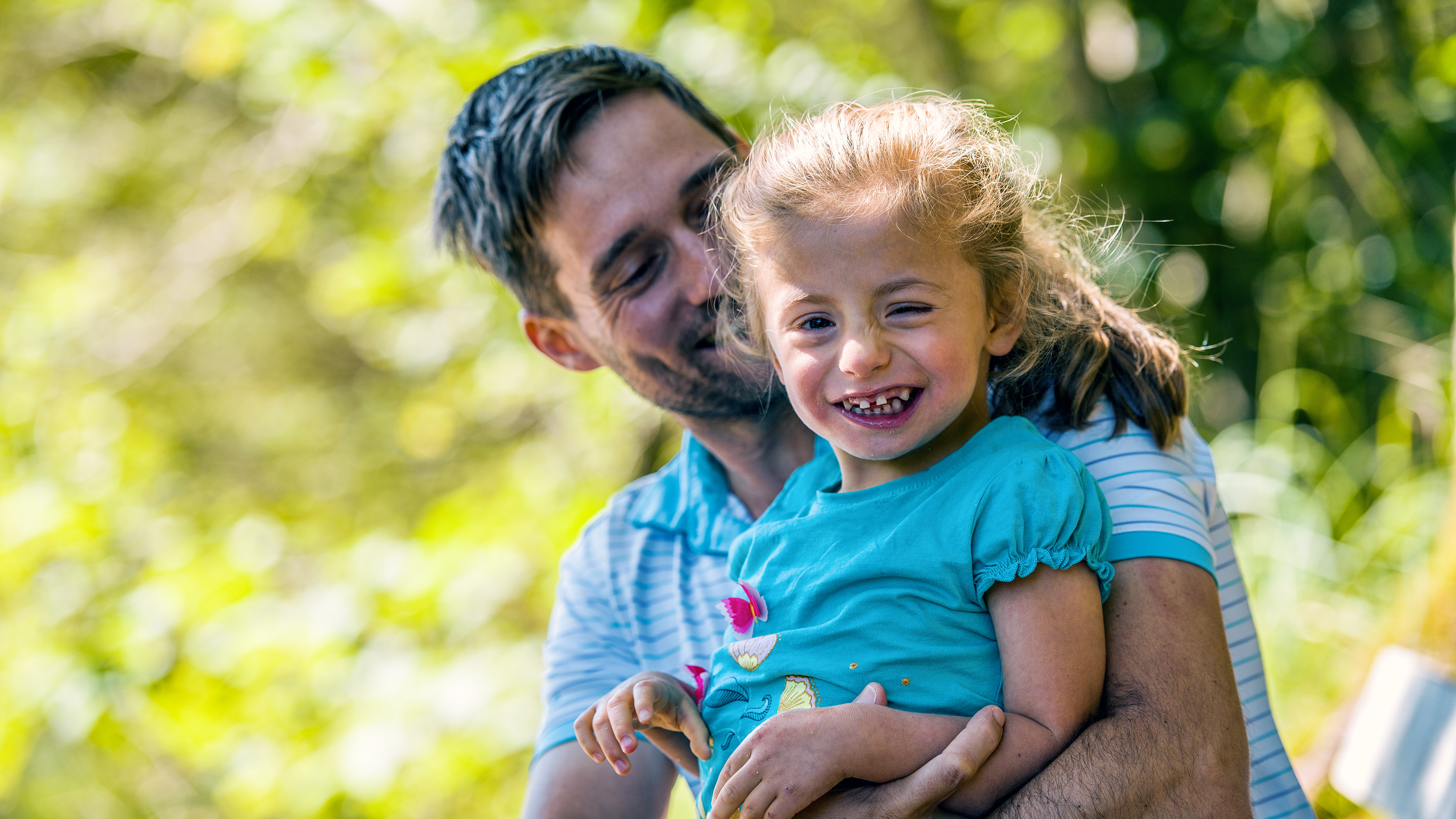 Andreas hat sein Kind Emilia im Arm.