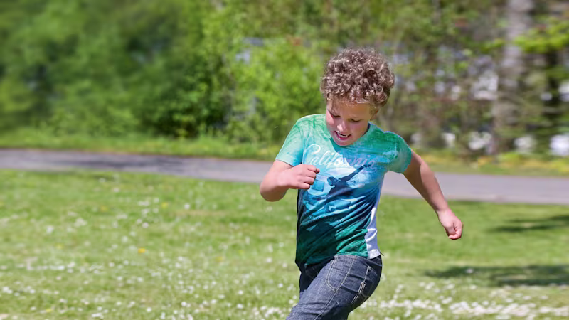 A child playing soccer with a prosthetic leg