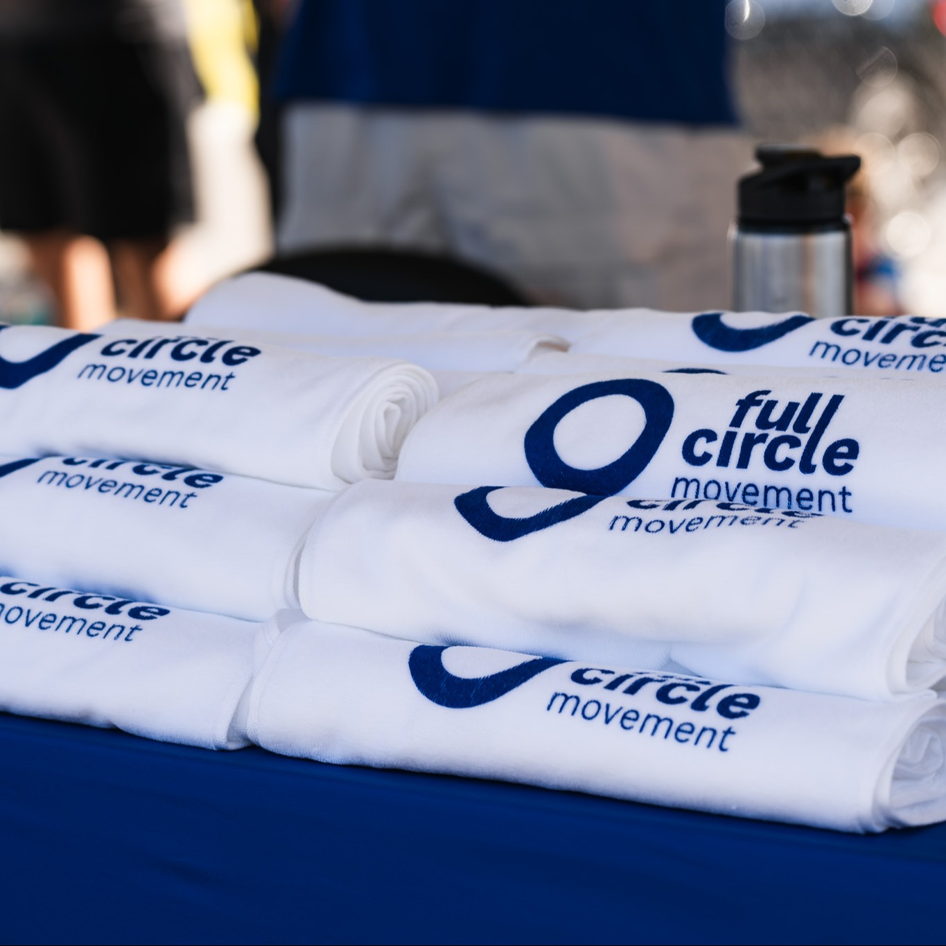 A stack of Full Circle Movement branded items on a table 