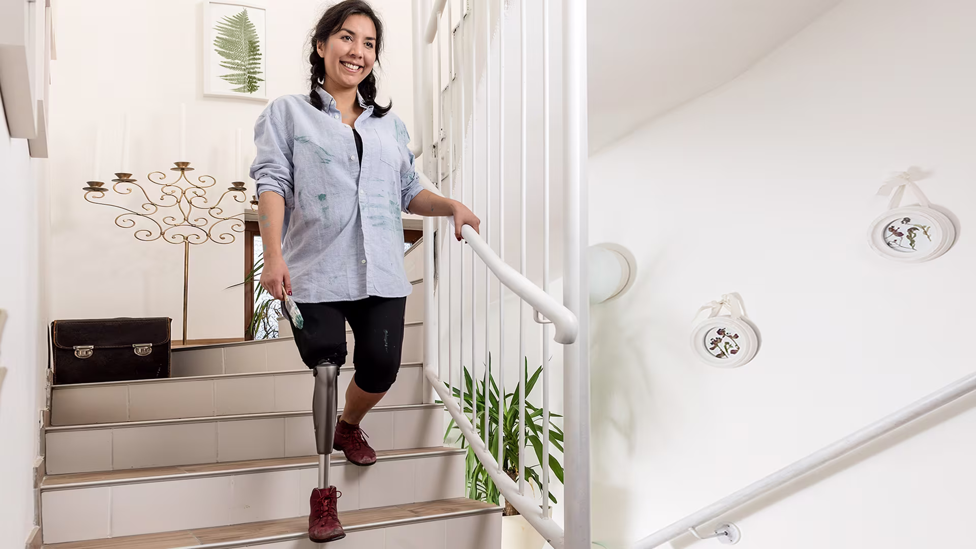 A lower limb amputee walks down a set of stairs with ease with the help of her Ottobock-manufactured microprocessor knee