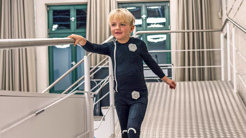 Cerebral palsy patient walking while holding railings