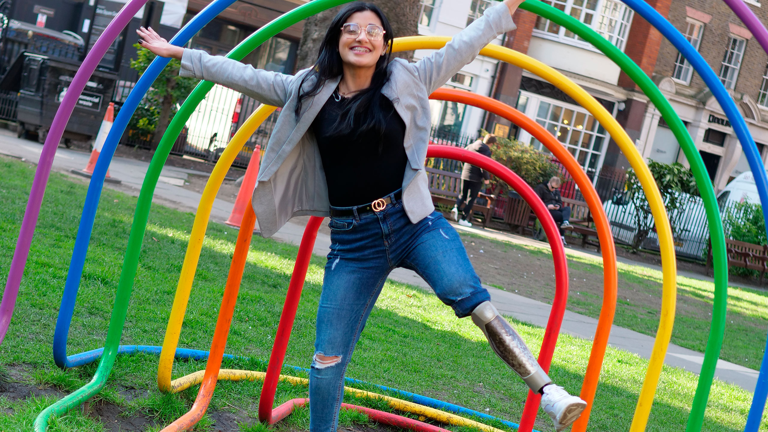 Dima poses exuberantly in front of an outdoor sculpture in her C-Leg 4