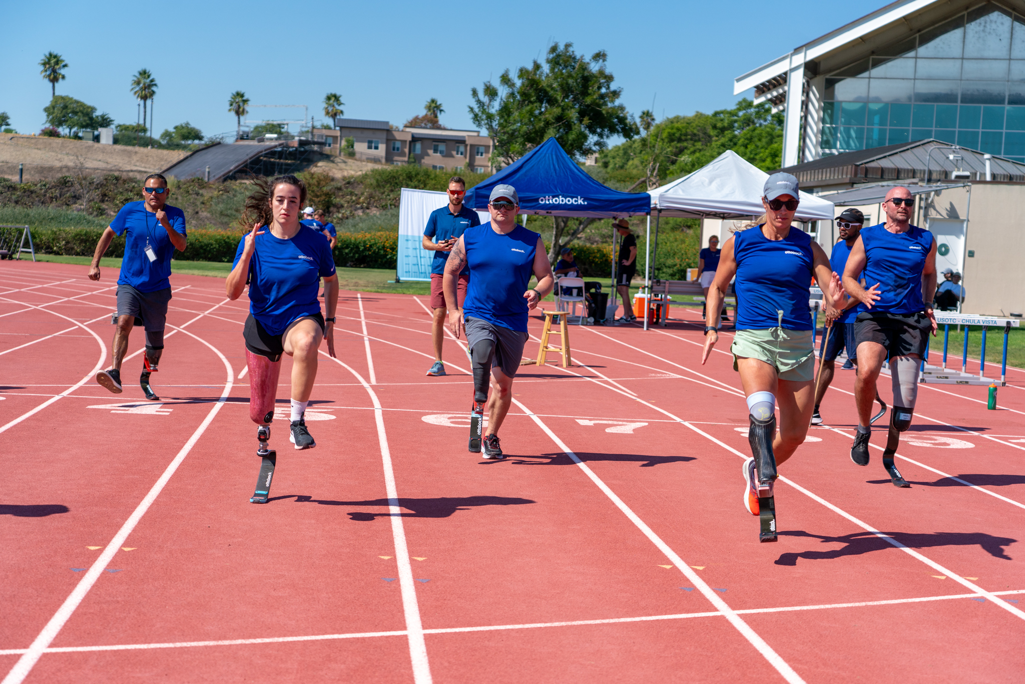 Running Clinic participants running on an outdoor track in Chula Vista, CA