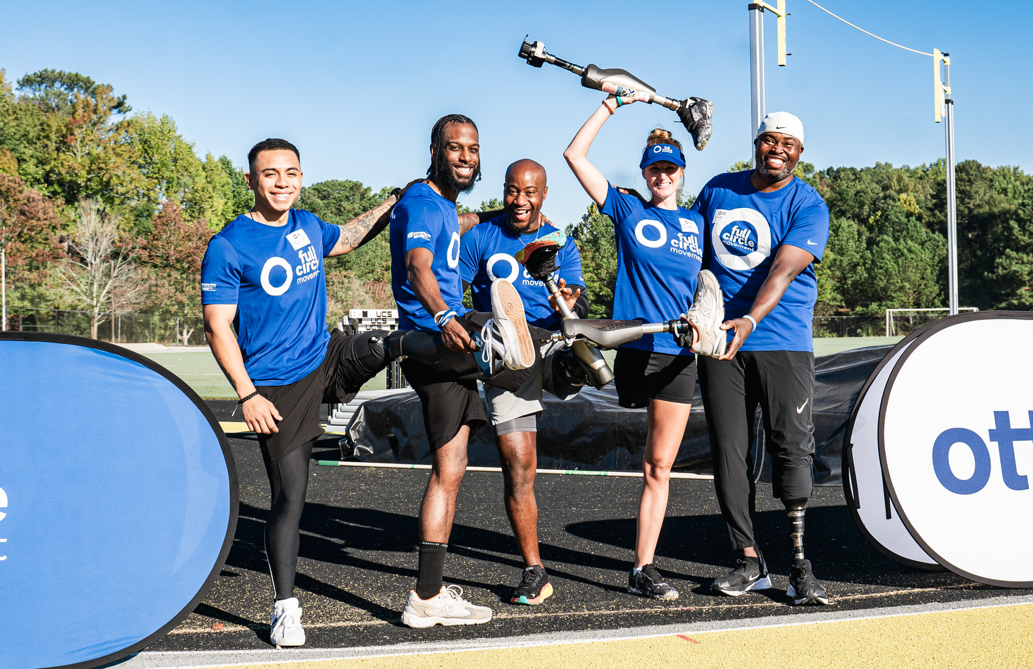 Ottobock Ambassador Carlos Brown posing with Full Circle Movement attendees 