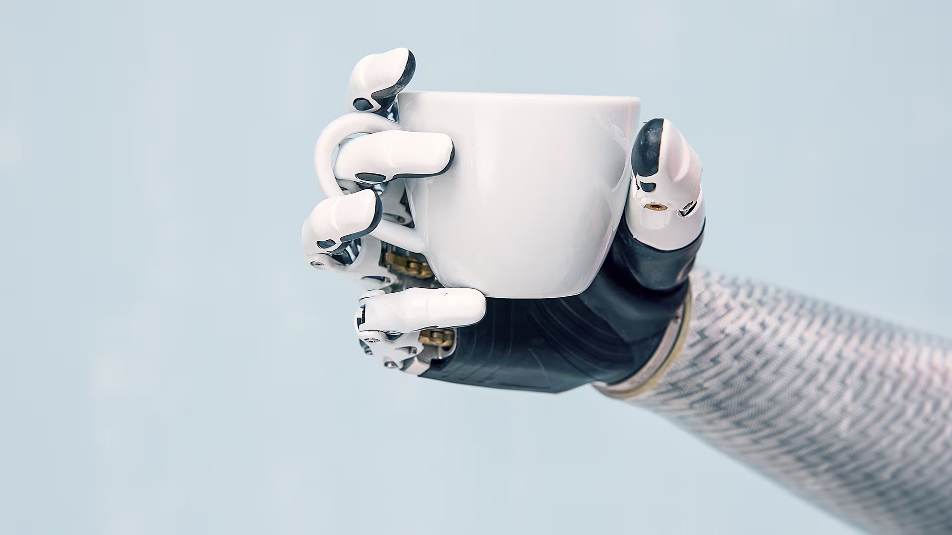 The custom, Ottobock-manufactured SpeedHand grasps a coffee mug