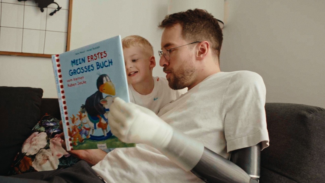 Andi Onea reading a book with his child
