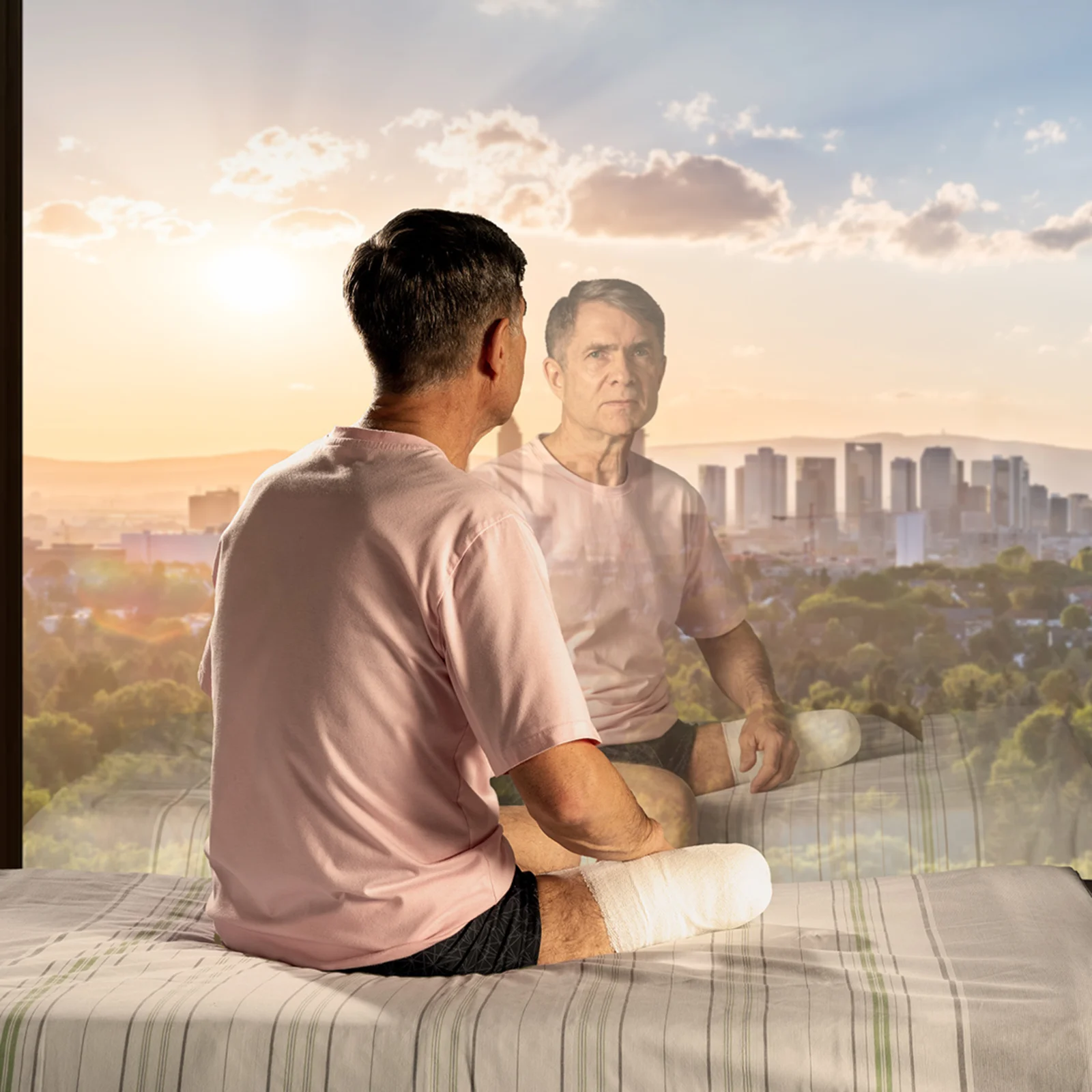 Man after amputation looks out of window