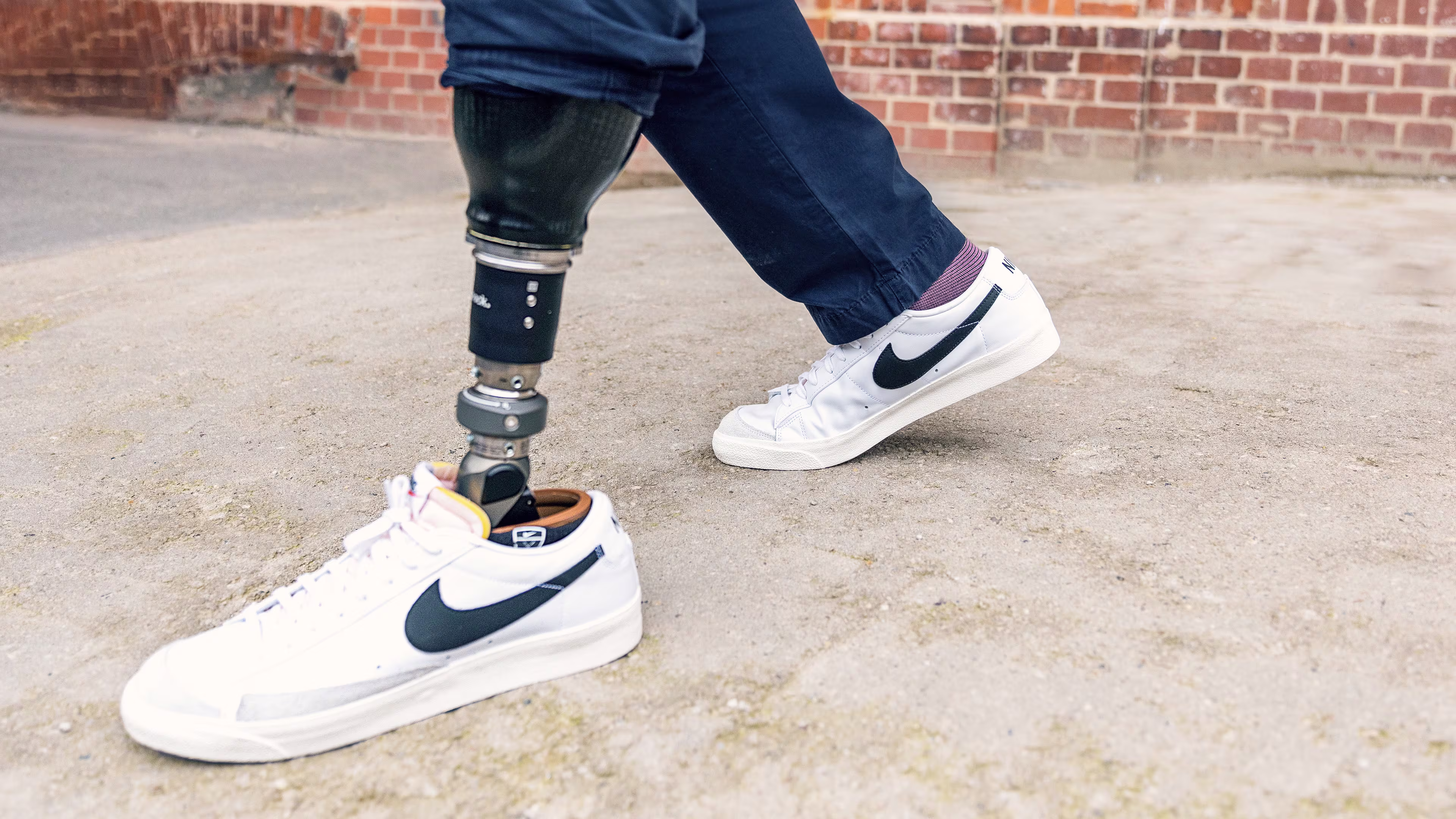 Taleo Adapt prosthetic foot user walking down a slope with sneaker shoes