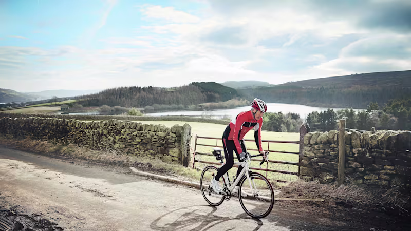 A cyclist riding through an outdoor trail