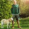Genium user Axel is standing in the park with his dog.