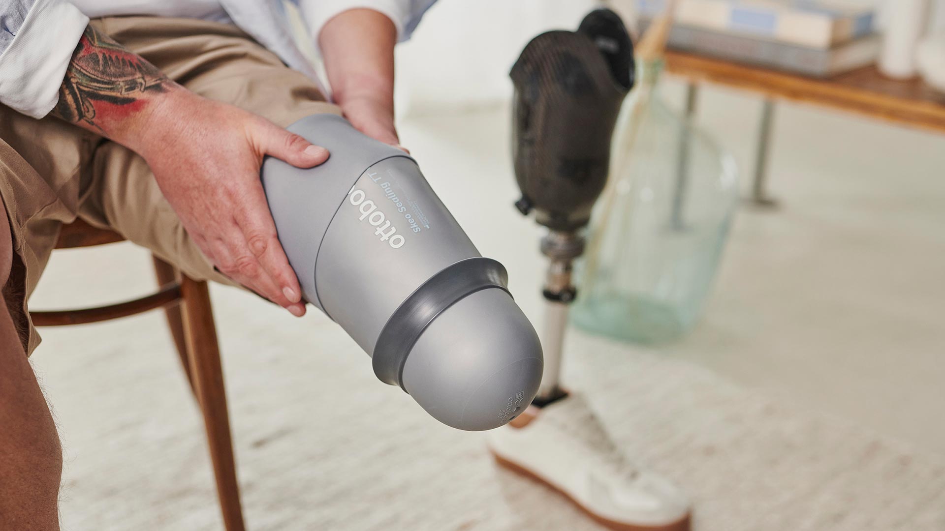 A below knee amputee adjusting their skeo sealing prosthetic liner on their residual limb