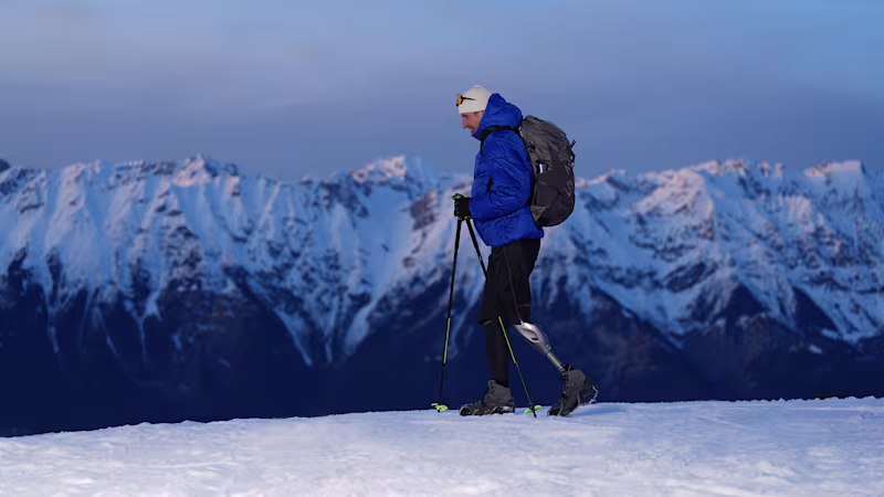 Genium X4 user Björn walking up a hill covered in snow