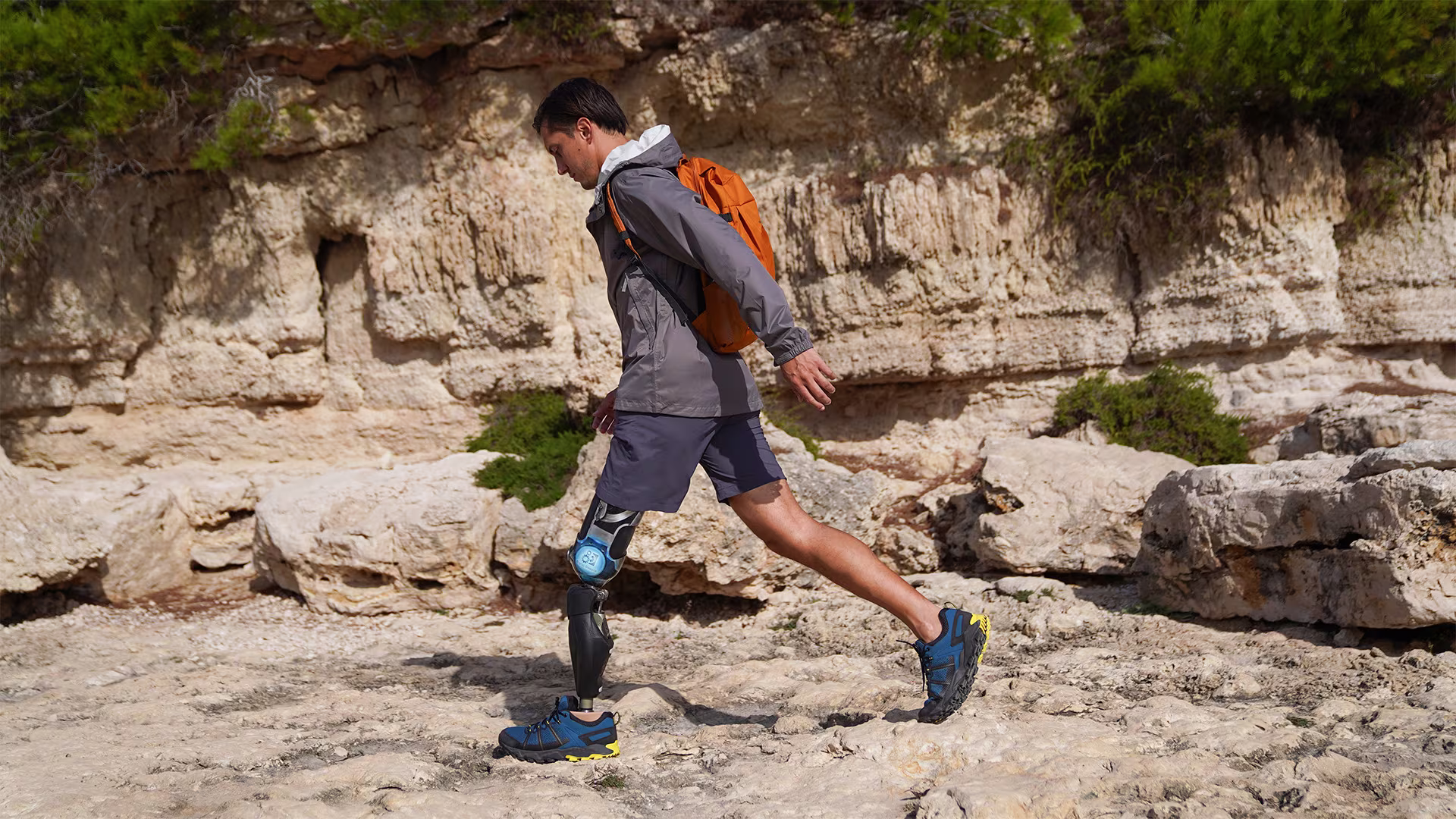 Alessandro Ossola with his Ottobock Evanto prosthetic foot and Genium X3 microprocessor knee walking across rocking ground from right to left.