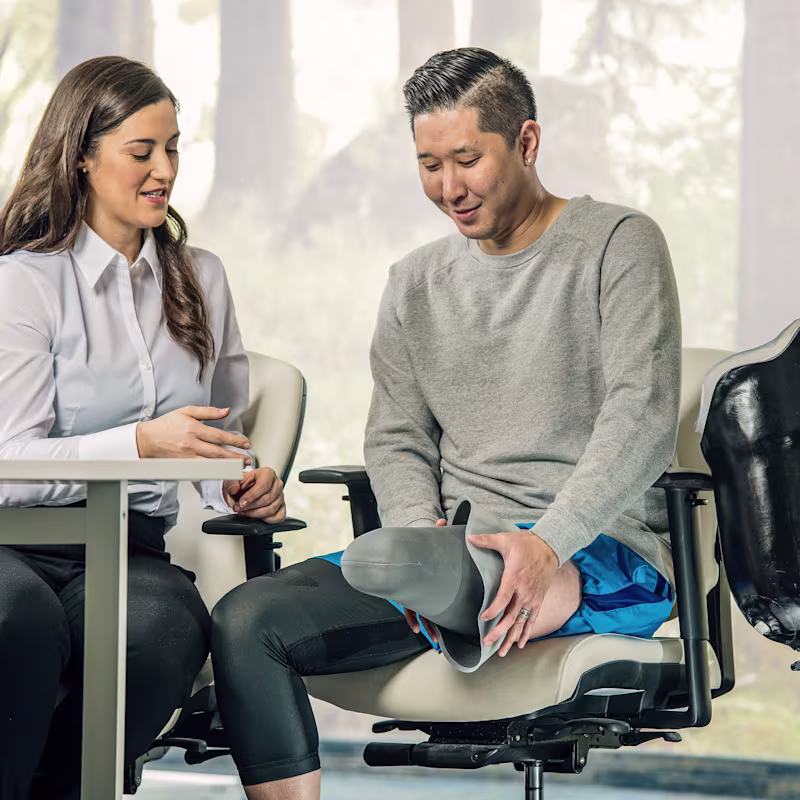 A Certified Prosthetist (CP) with a lower limb prosthetic user to discuss prosthetic limb options